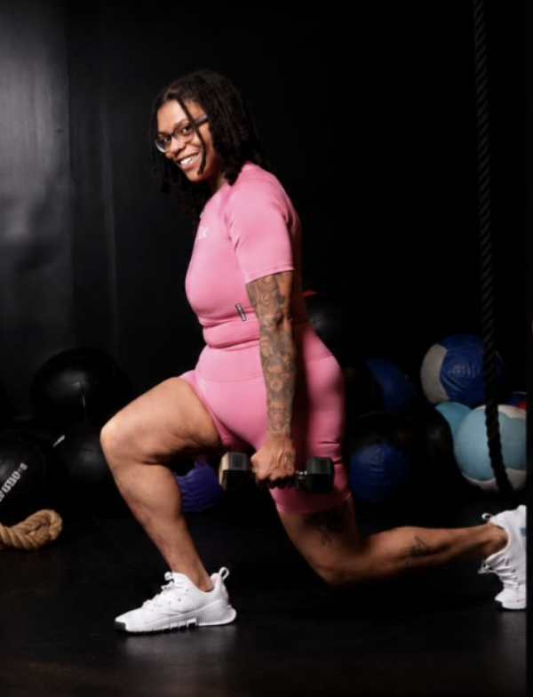 Alexis 'Lex', ISSA certified personal trainer, performing a dumbbell lunge in her Maryland gym
